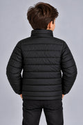 Young boy wearing black horizontal quilted winter puffer jacket back view