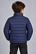 Young boy wearing navy blue horizontal quilted winter puffer jacket back view