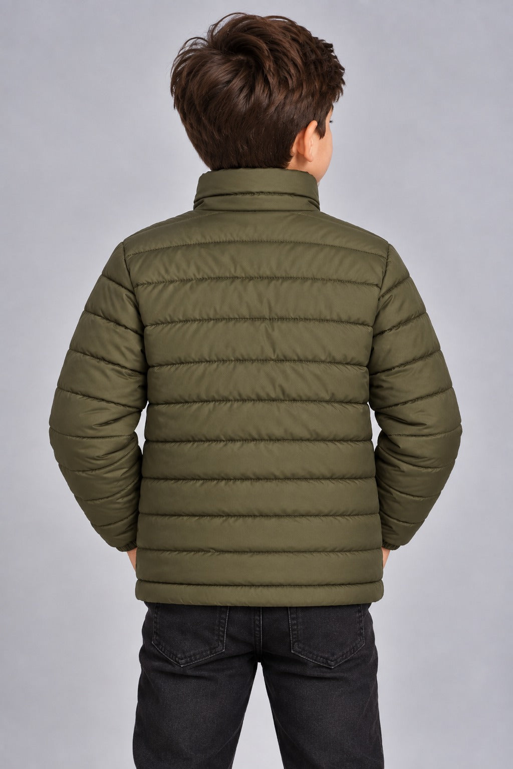 Young boy wearing olive green lightweight quilted puffer jacket front view with zip closure
