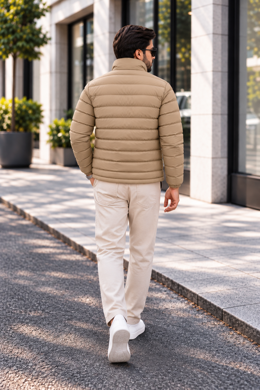 Man wearing khaki beige horizontal quilted winter puffer jacket street style back view walking