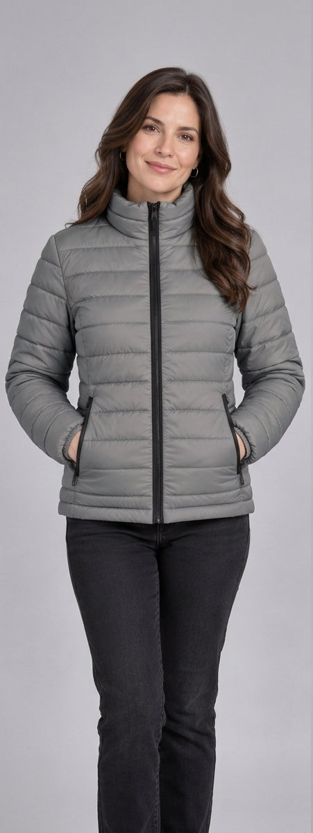 Woman wearing light grey lightweight quilted puffer jacket front view with zip closure and stand collar