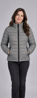 Woman wearing light grey lightweight quilted puffer jacket front view with zip closure and stand collar