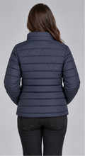 Woman wearing navy blue horizontal quilted winter puffer jacket clean back view